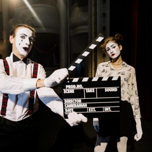 male-mime-artist-holding-clapperboard-front-female-mime-artist