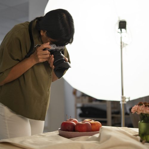 medium-shot-photographer-taking-fruit-photos
