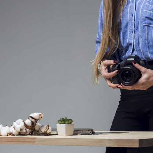 table-with-delicious-food-woman-holding-camera
